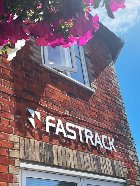 A brick building with a sign that says fasttrack.